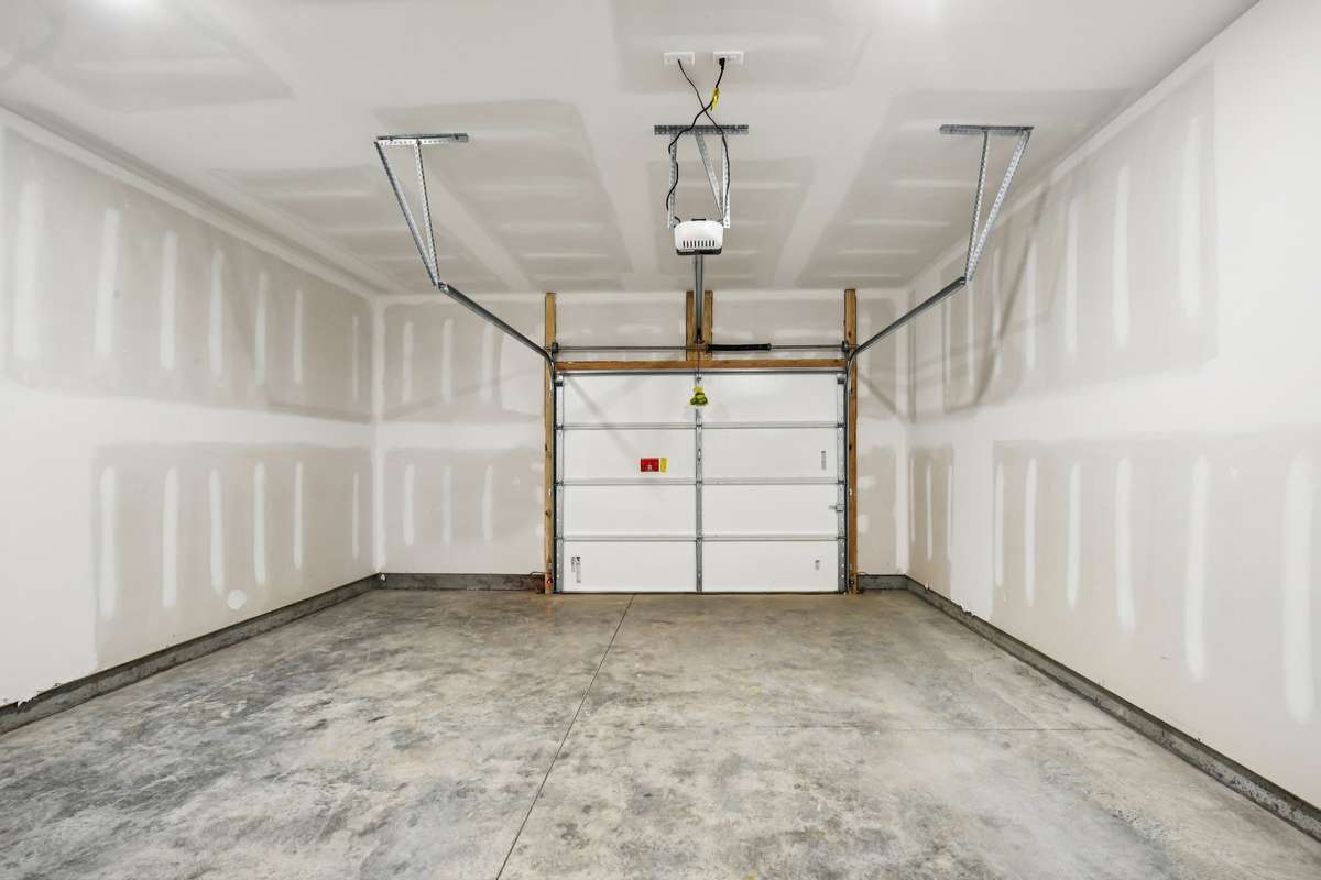 An oversized one-car garage with extra storage space and a dedicated driveway spot adds convenience and practicality.