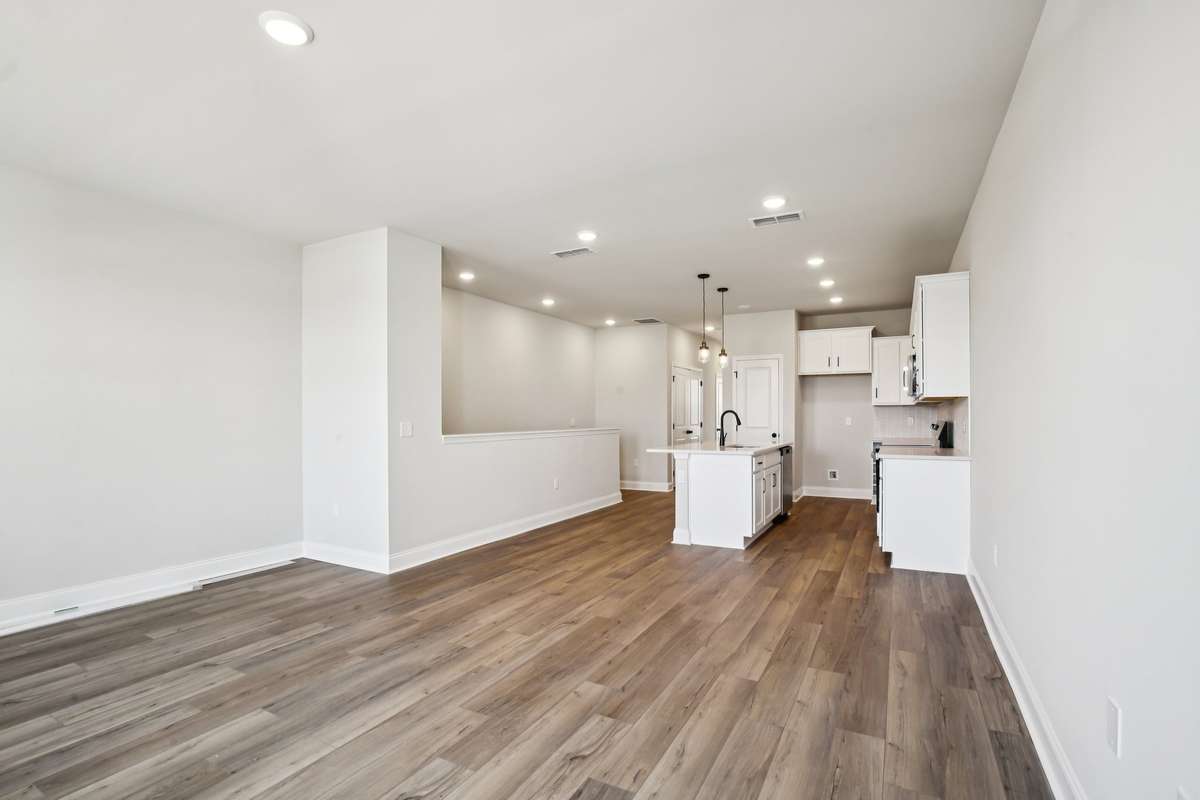 The main living area boasts an open-concept design, seamlessly connecting the great room, dining area, and kitchen for a bright, spacious, and inviting feel.