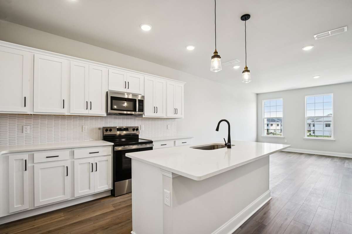 Durable LVP flooring is included throughout the main living areas, offering a stylish look with low-maintenance convenience and long-lasting performance.