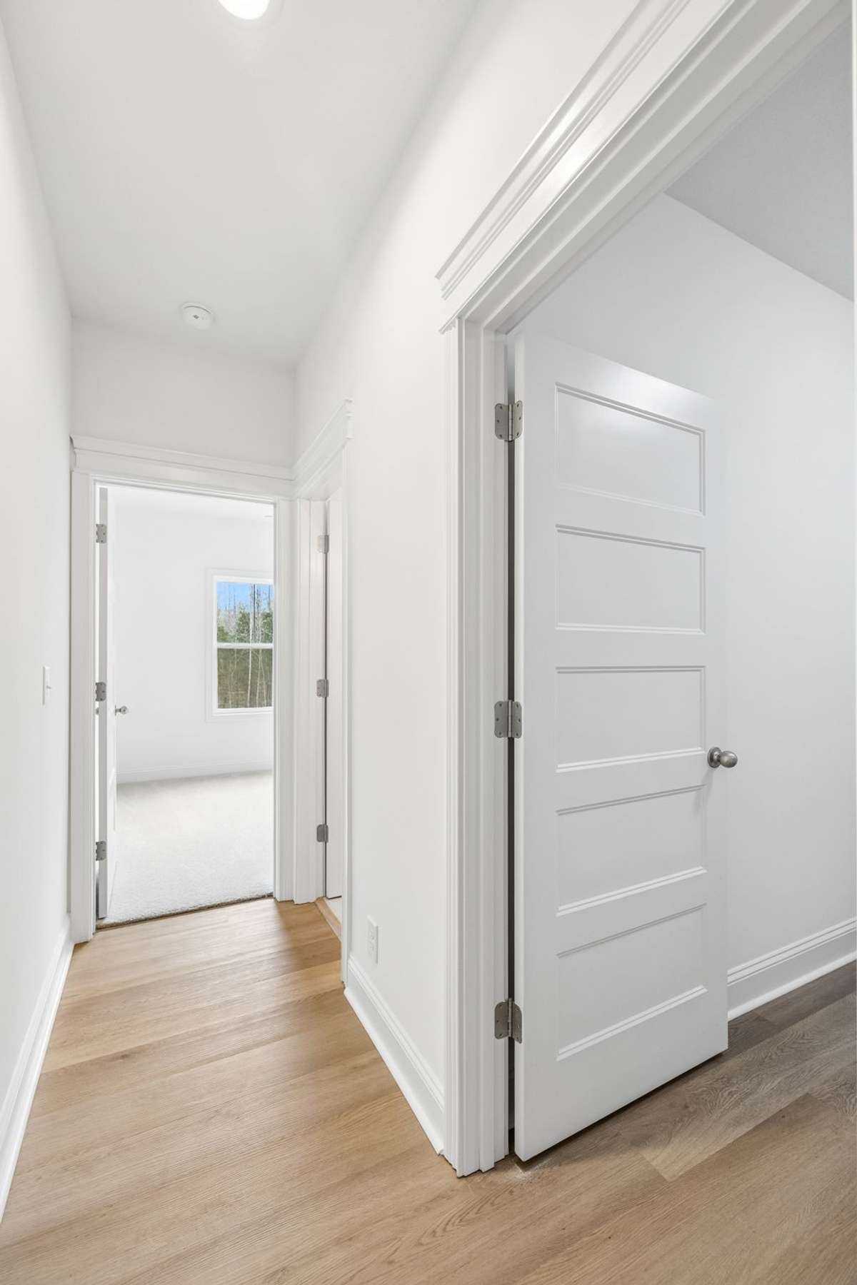 this is the hallway on opposite side of home from primary bedroom.  It has the laundry room, a full bath and an office (which could be used as a guest room as well)