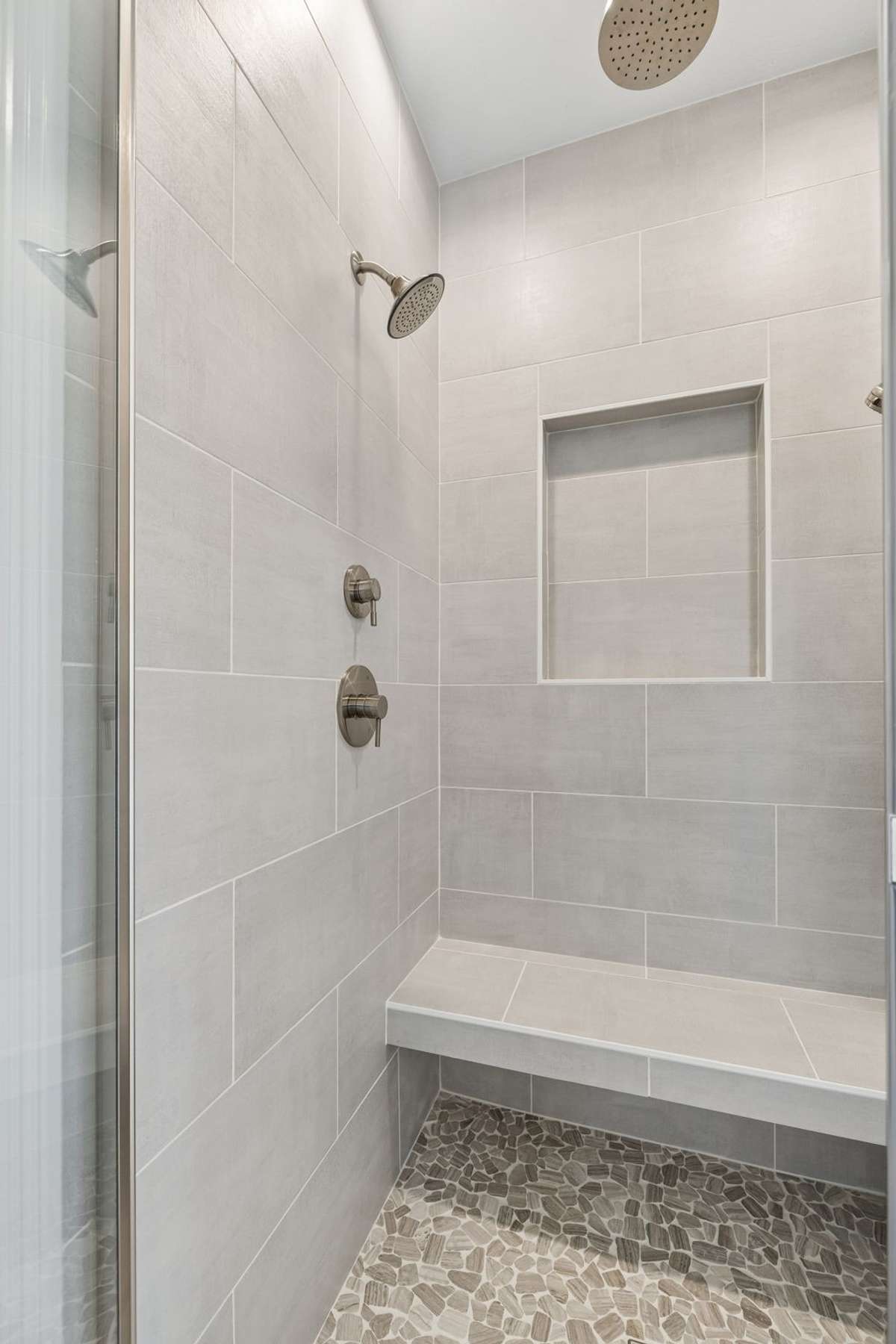 walk in tile shower with seat in primary bath