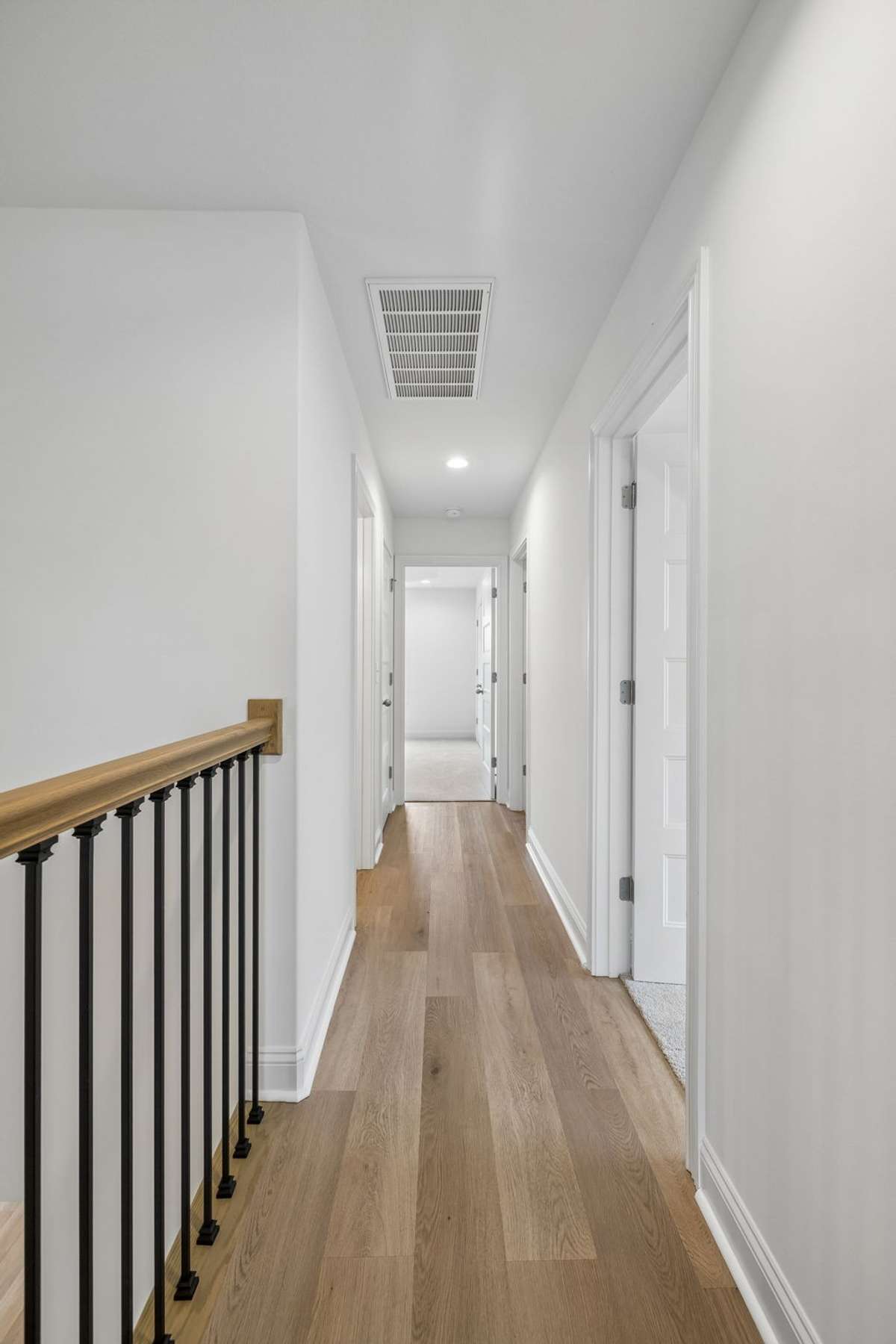 Hallway leading to the other bedrooms, bonus room and full bath