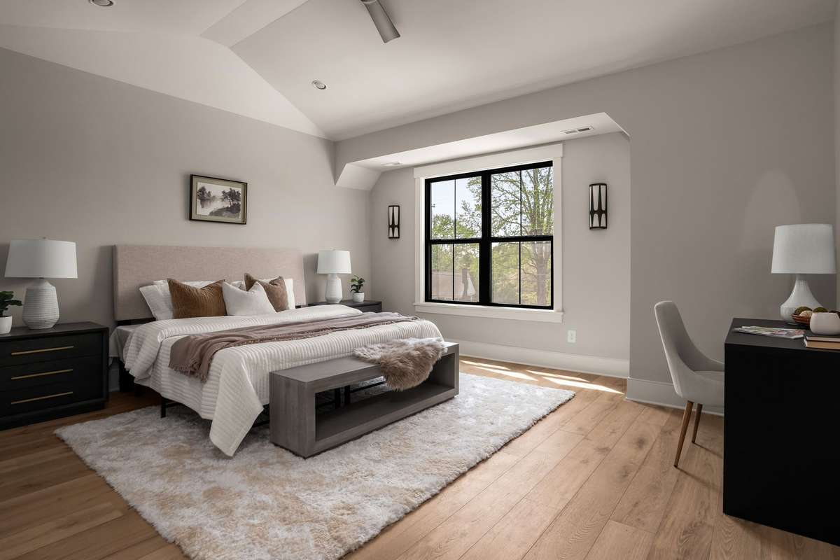 Primary bedroom with vaulted ceilings