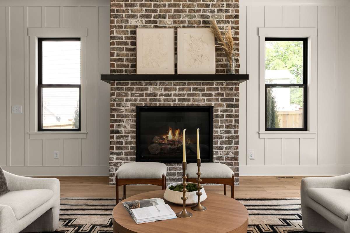The living room features a brick gas fireplace