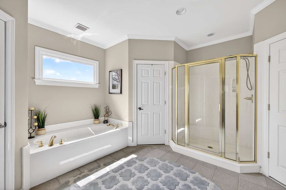 The large shower is separate from the soaking tub, dual closets, and a private water closet.