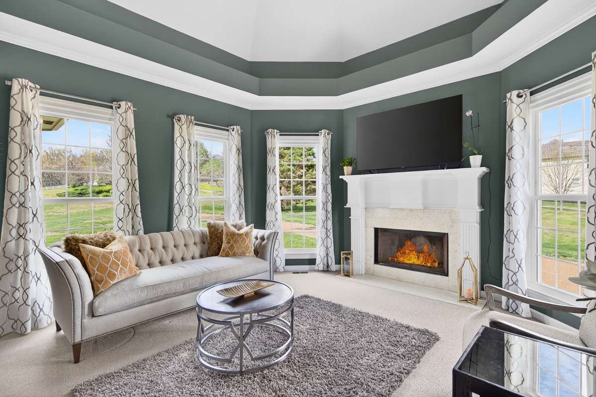 This other living space is also open to the kitchen and features a fireplace and a fun vaulted ceiling treatment.