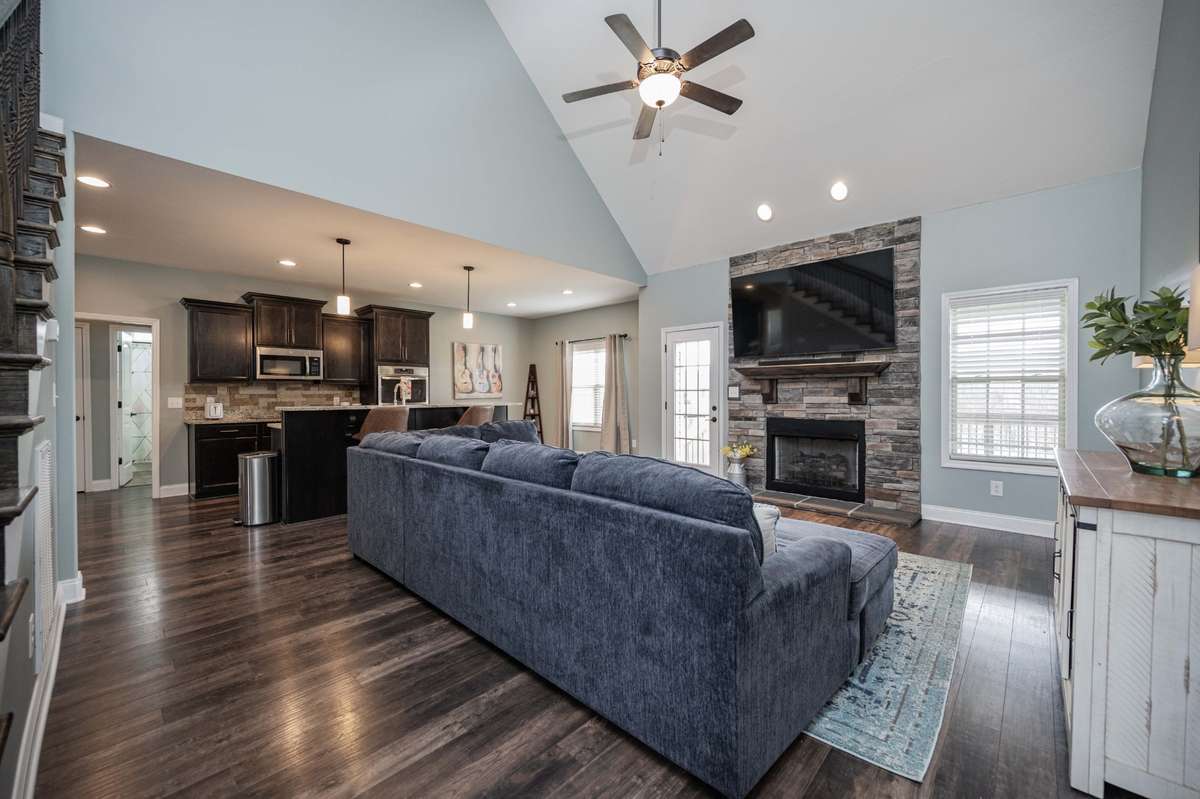 Open layout flows from the vaulted family room with stone fireplace through to the kitchen, so conversation carries easily between spaces.