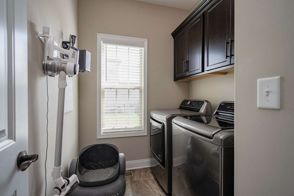 Laundry room on the main level keeps the weekly routine close to the bedrooms and kitchen without extra trips upstairs. Washer/dryer (2 yrs) remains.