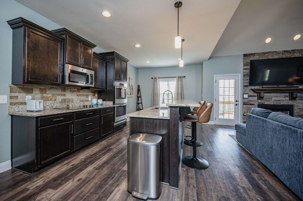 Kitchen island with bar seating keeps family and friends close while meals come together on the other side.