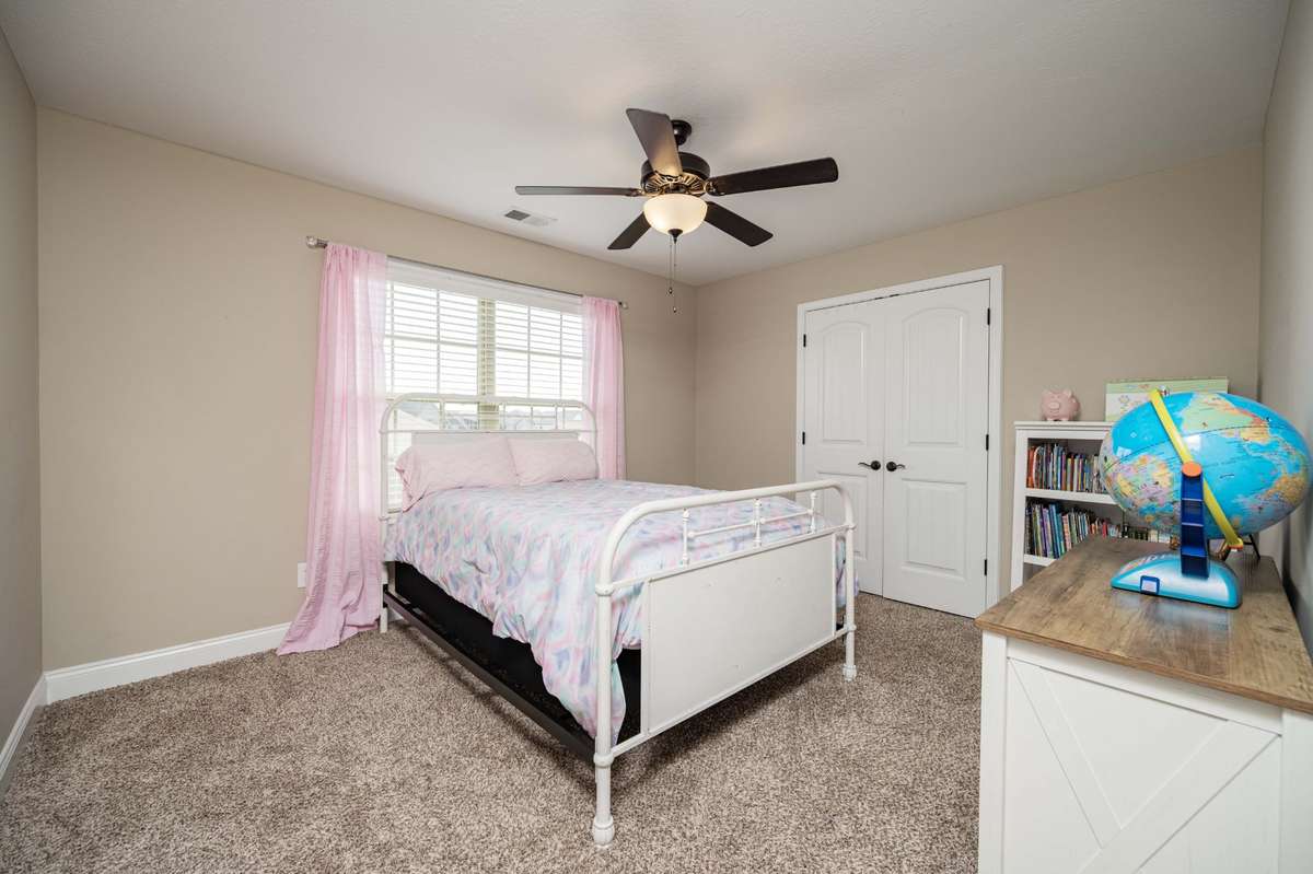 Bedroom 4 upstairs with natural light from the wide window.