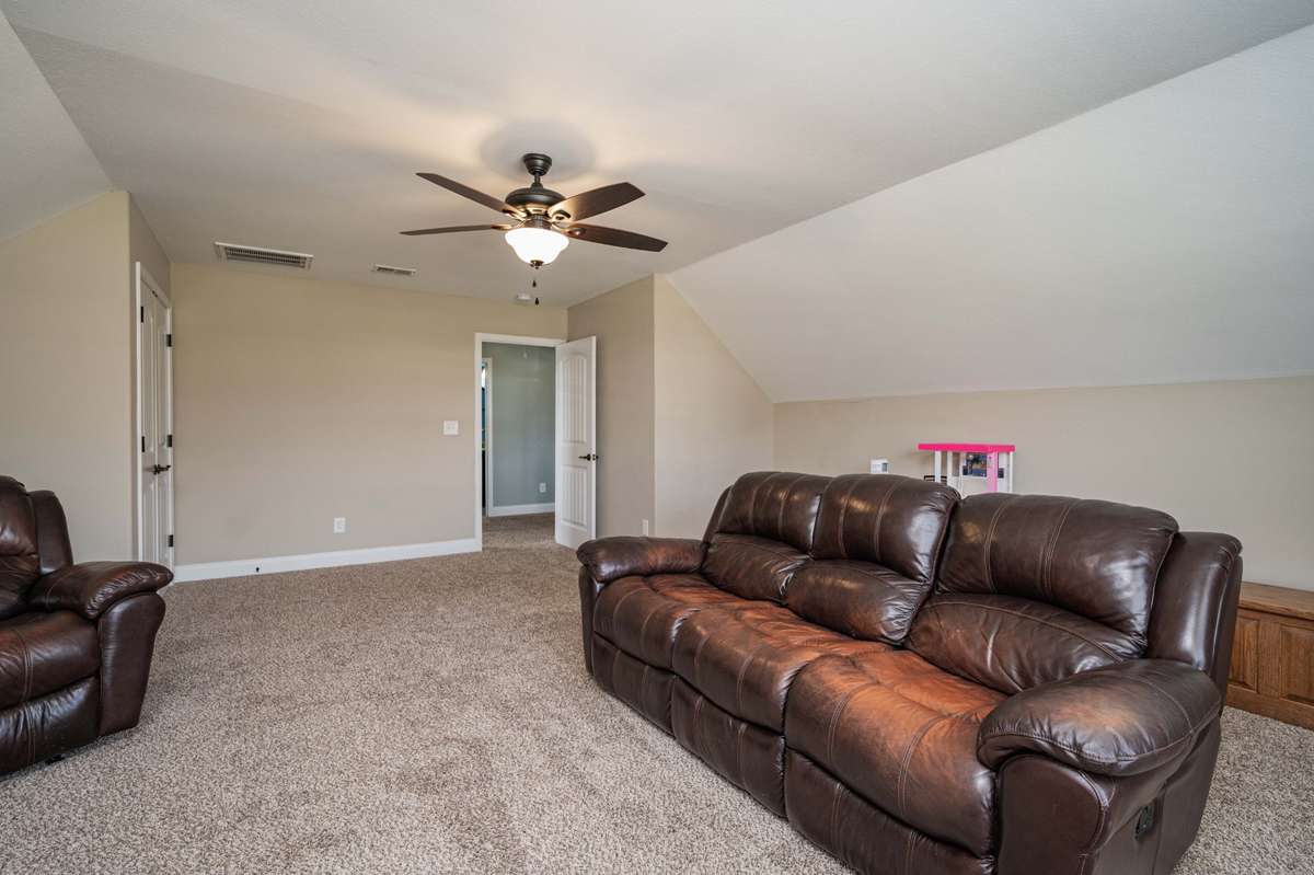 Bonus room upstairs could go either way — office, playroom, or extra sleeping space with vaulted ceilings that open up the feel.