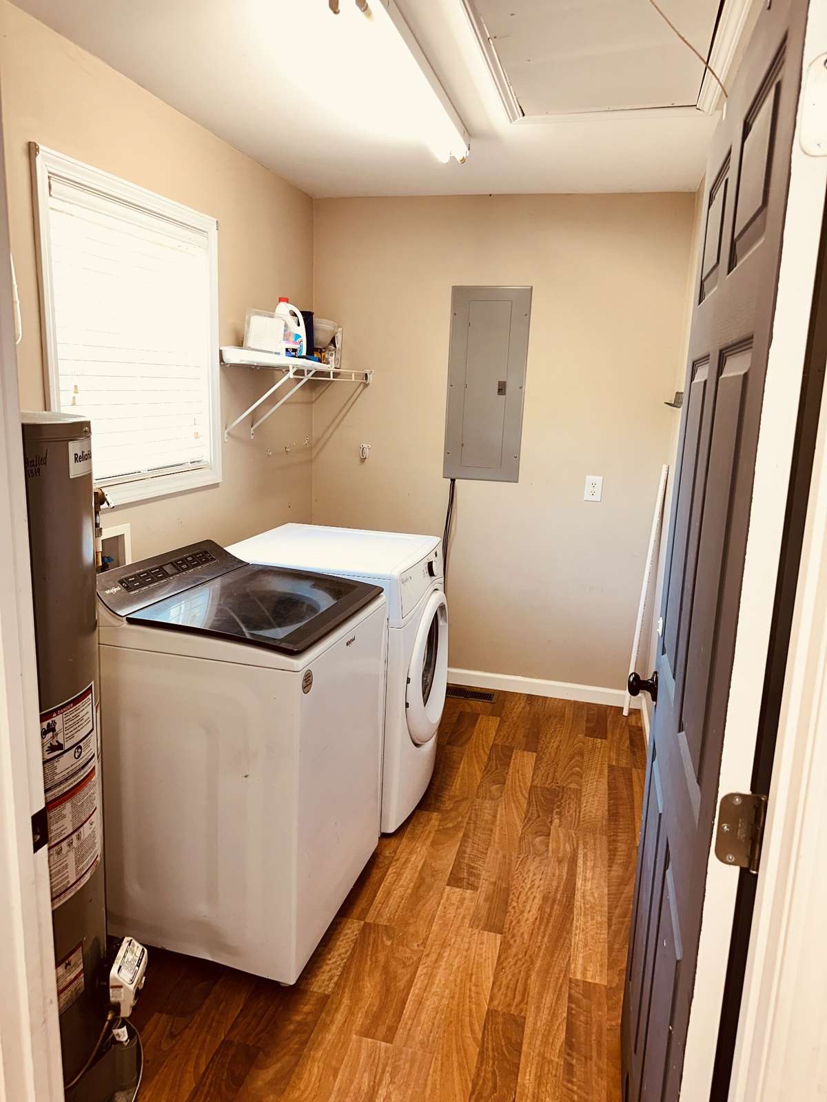 Utility room with washer/dryer and attic access. Washer/dryer remain.