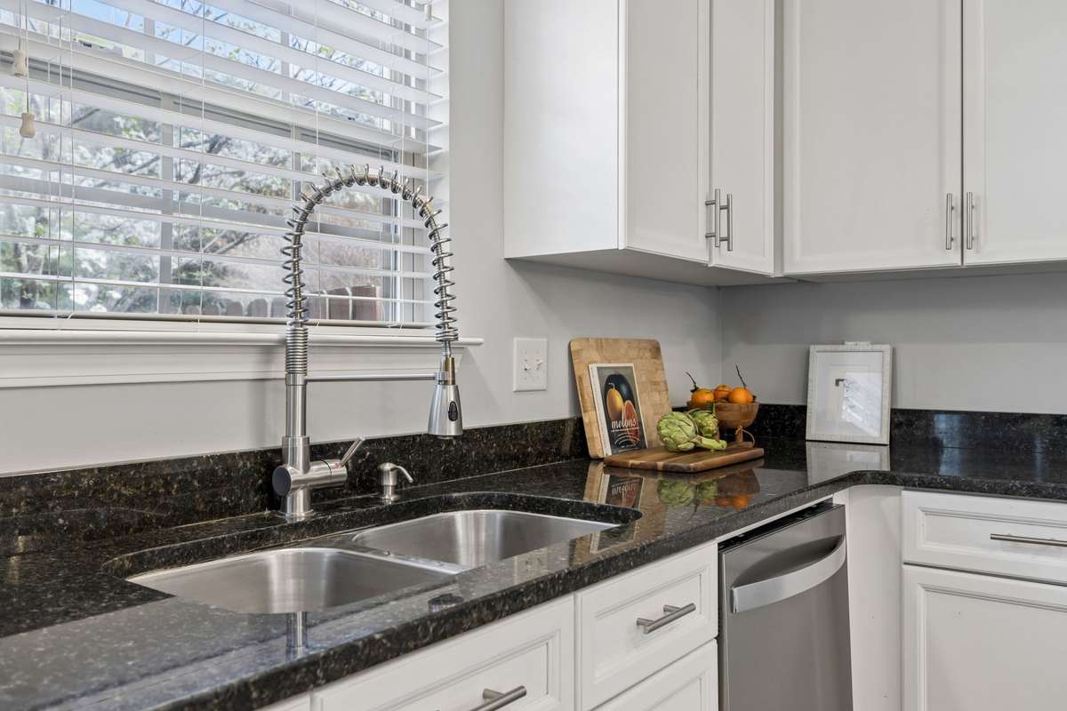 A double stainless sink and upgrade kitchen faucet are nice enhancements to this space.