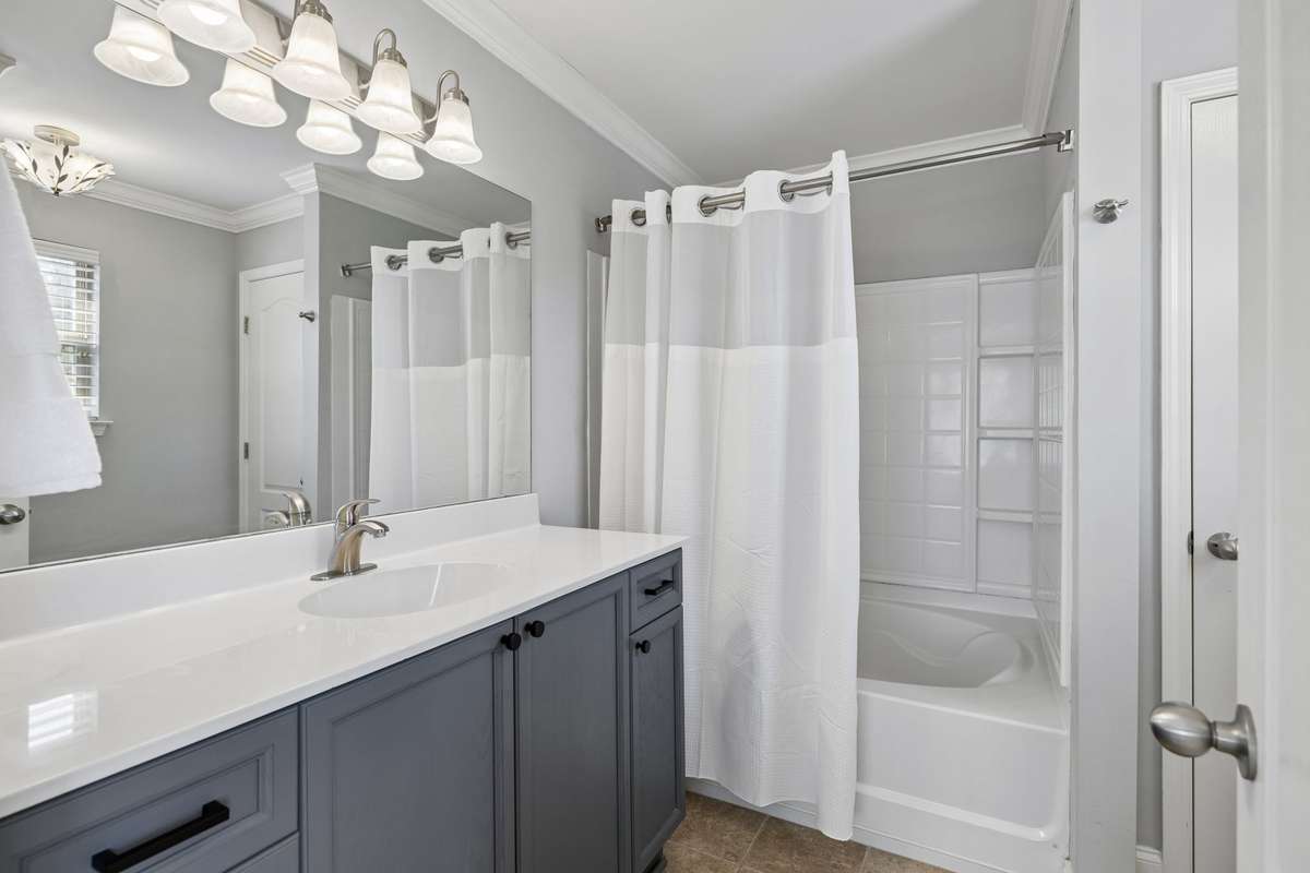 The primary bath offers an abundance of counter space and an oversized shower and tub.
