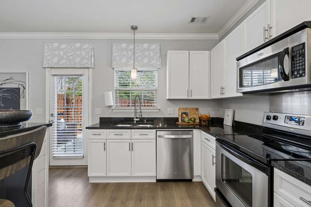 The kitchen sink overlooks the outdoor patio and blooming Dogwood tree ~ doing dishes won't be a chore here!