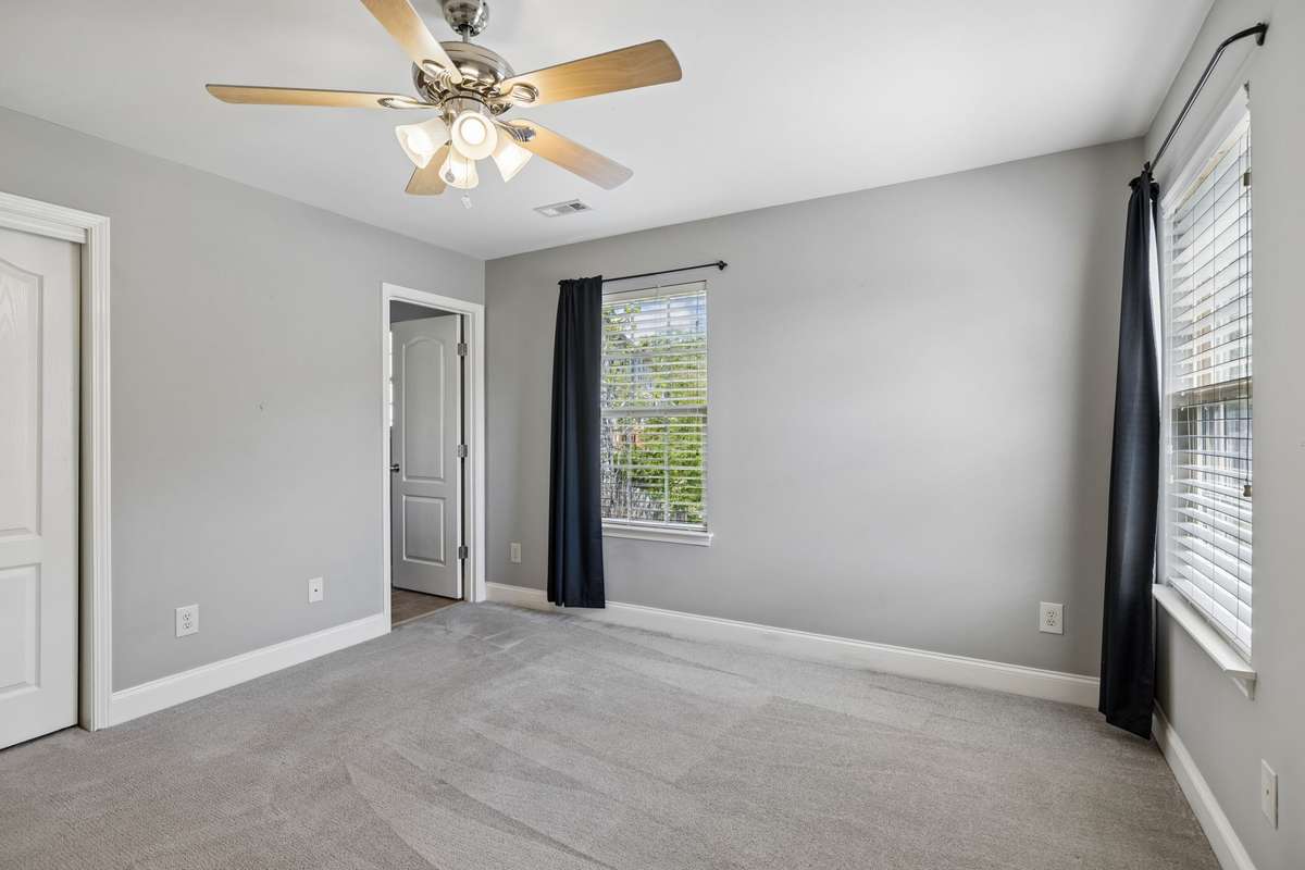 This room has lovely views out both windows, with the back overlooking the community pond and tree line.