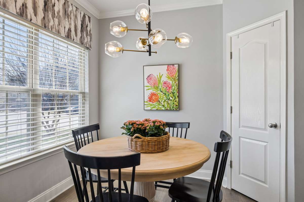What a charming dining area!  The large pantry beyond the door offers plenty of stage space for food, appliances and more.