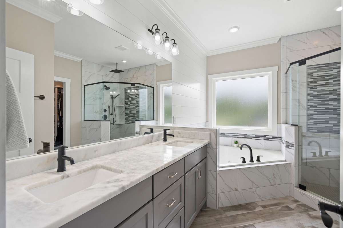 Owners suite Bath with separate tub/shower, linen closet and large walk in closet with built in shelving.