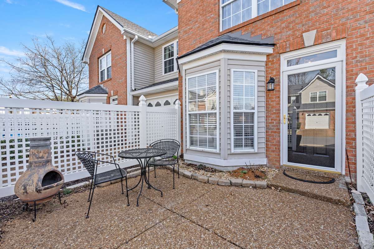 The fenced front patio offers private outdoor space aside the one-car garage!
