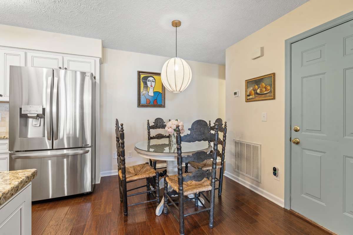 The combination dining space leads to the large pantry, powder bath and garage access.