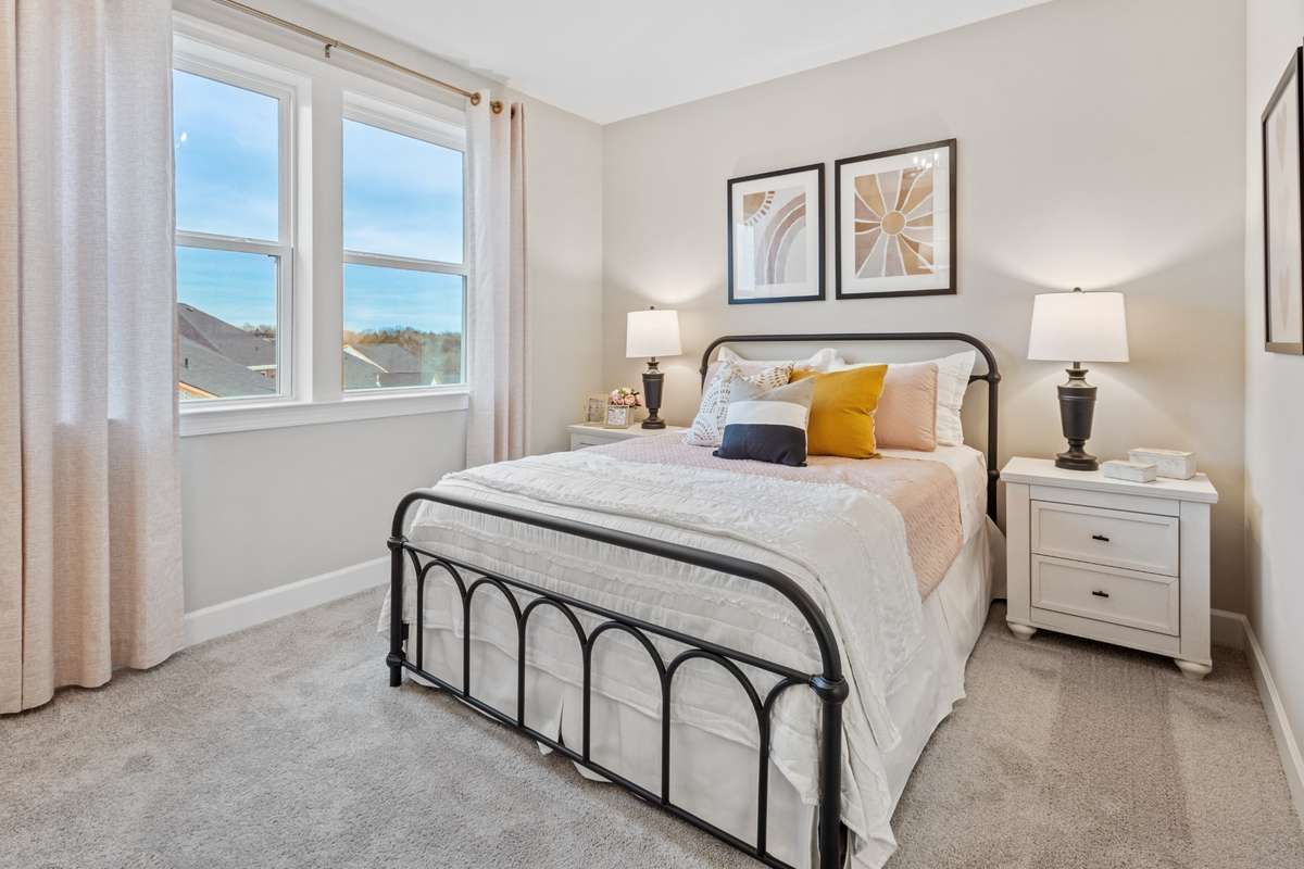 1 of 3 guest bedrooms upstairs with walk-in closet.