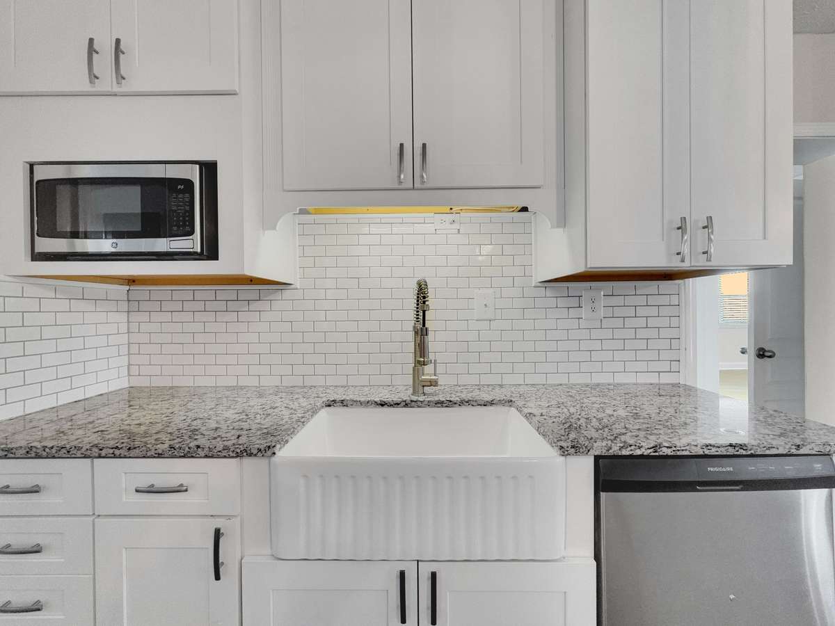 Farmhouse sink paired with elegant granite countertops.