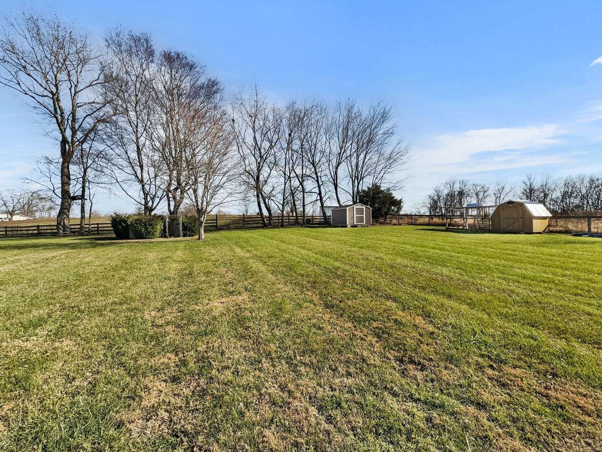 Spacious backyard overlooking the rear pasture, offering beautiful views and plenty of room to enjoy the outdoors.