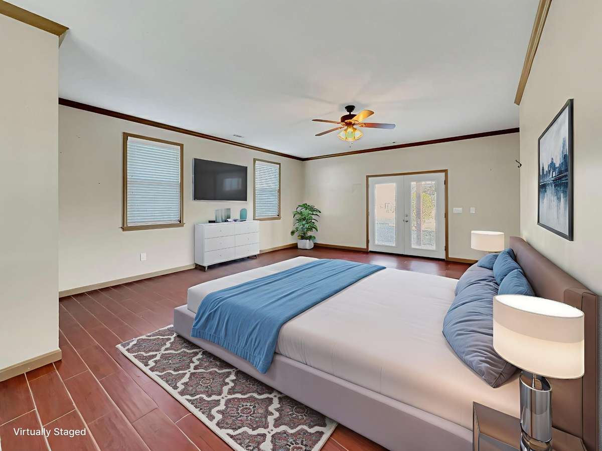 Main-level primary bedroom featuring a private exterior entrance to the back porch.