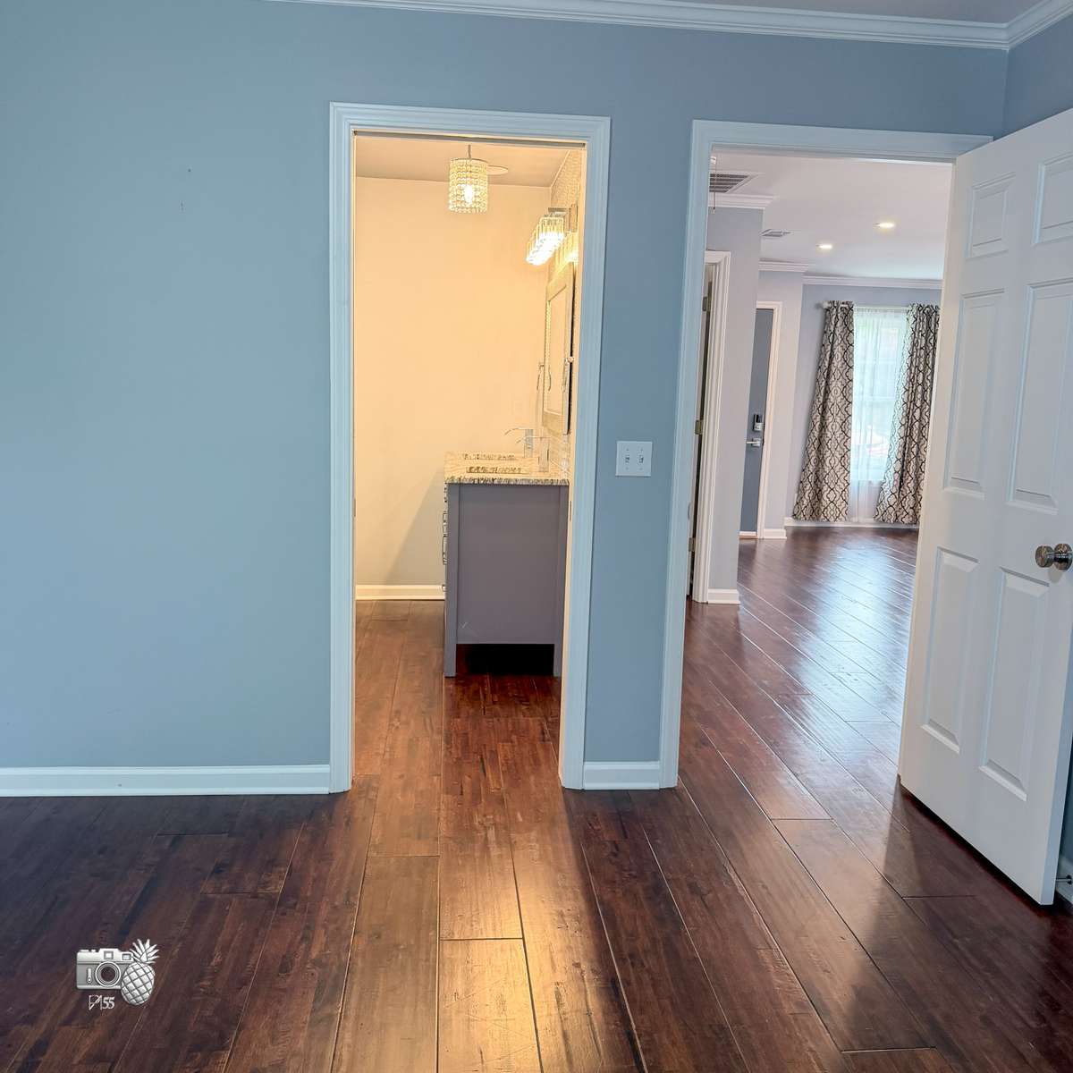Primary bedroom - view of bathroom and living room