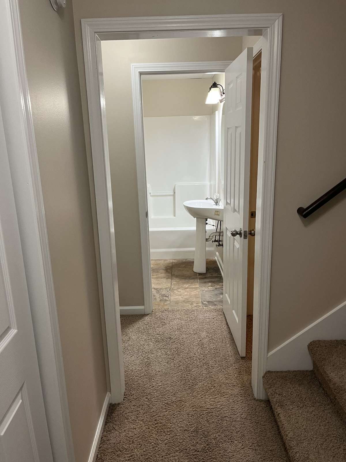 View down hallway to full bath