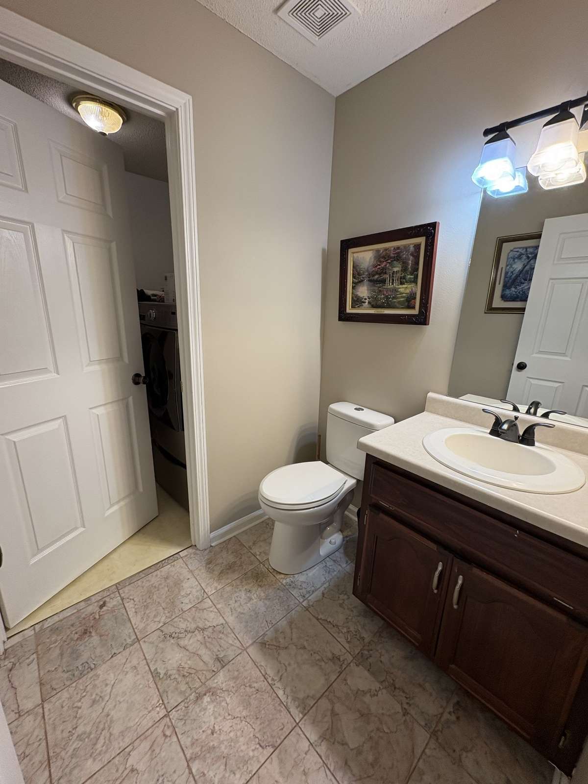 Downstairs half bath with laundry room