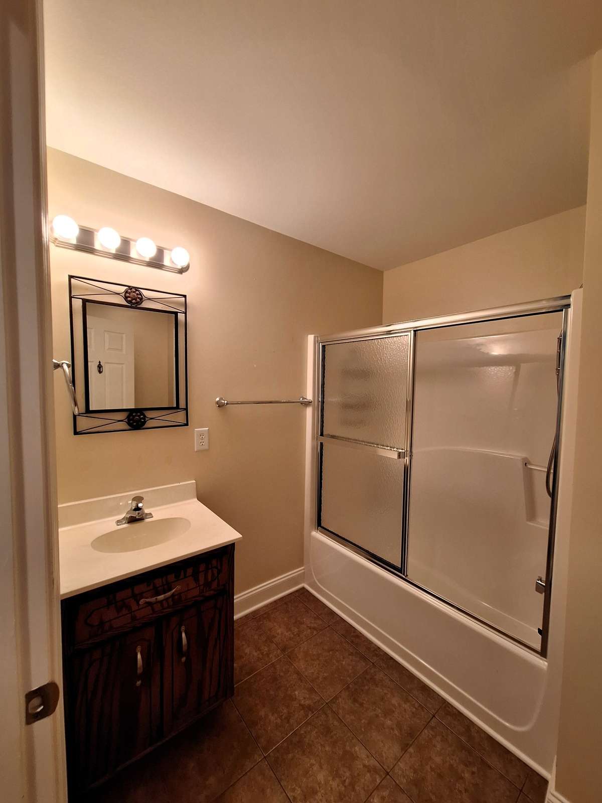 Guest Bathroom with tile floors, matching vanity, and a tub/shower condo!!