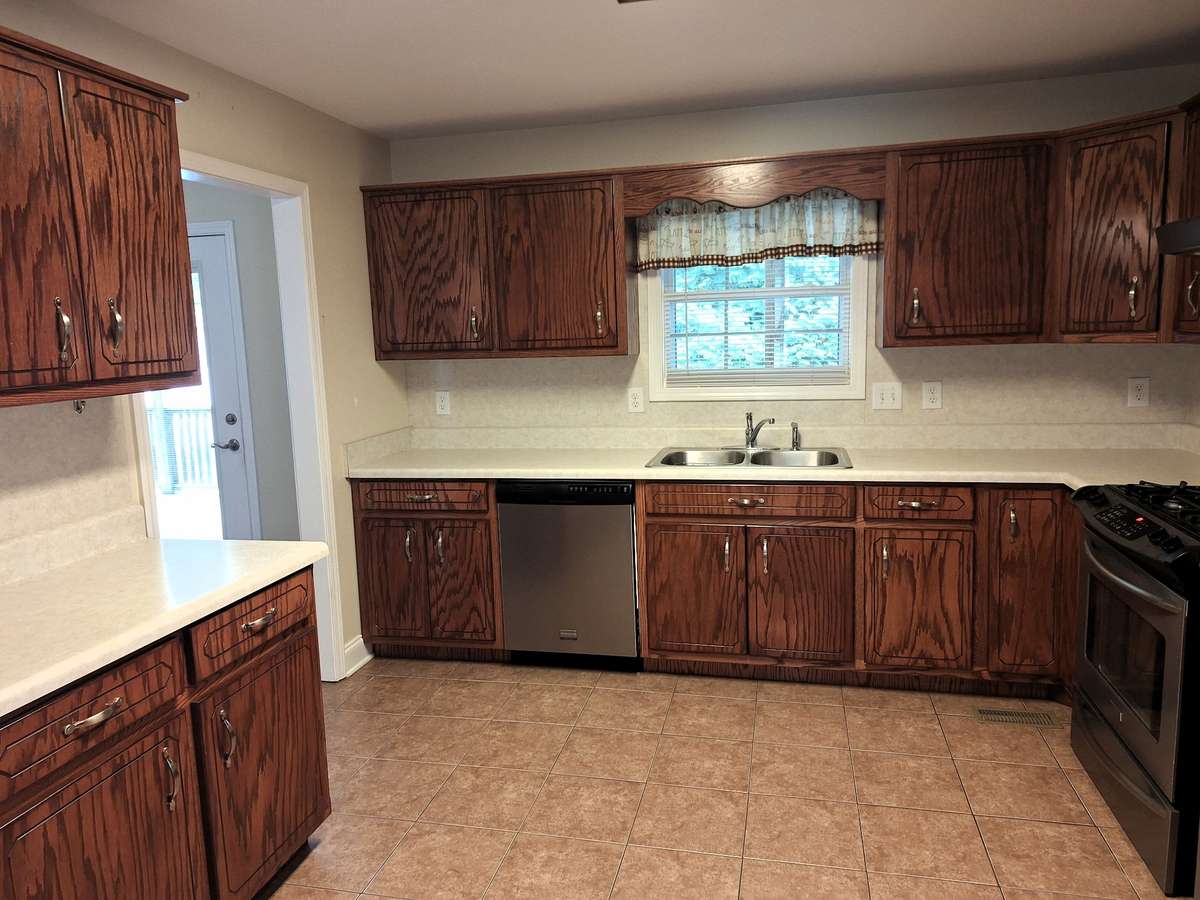 Spacious Kitchen with Tile Floors and hardwood cabinets!!