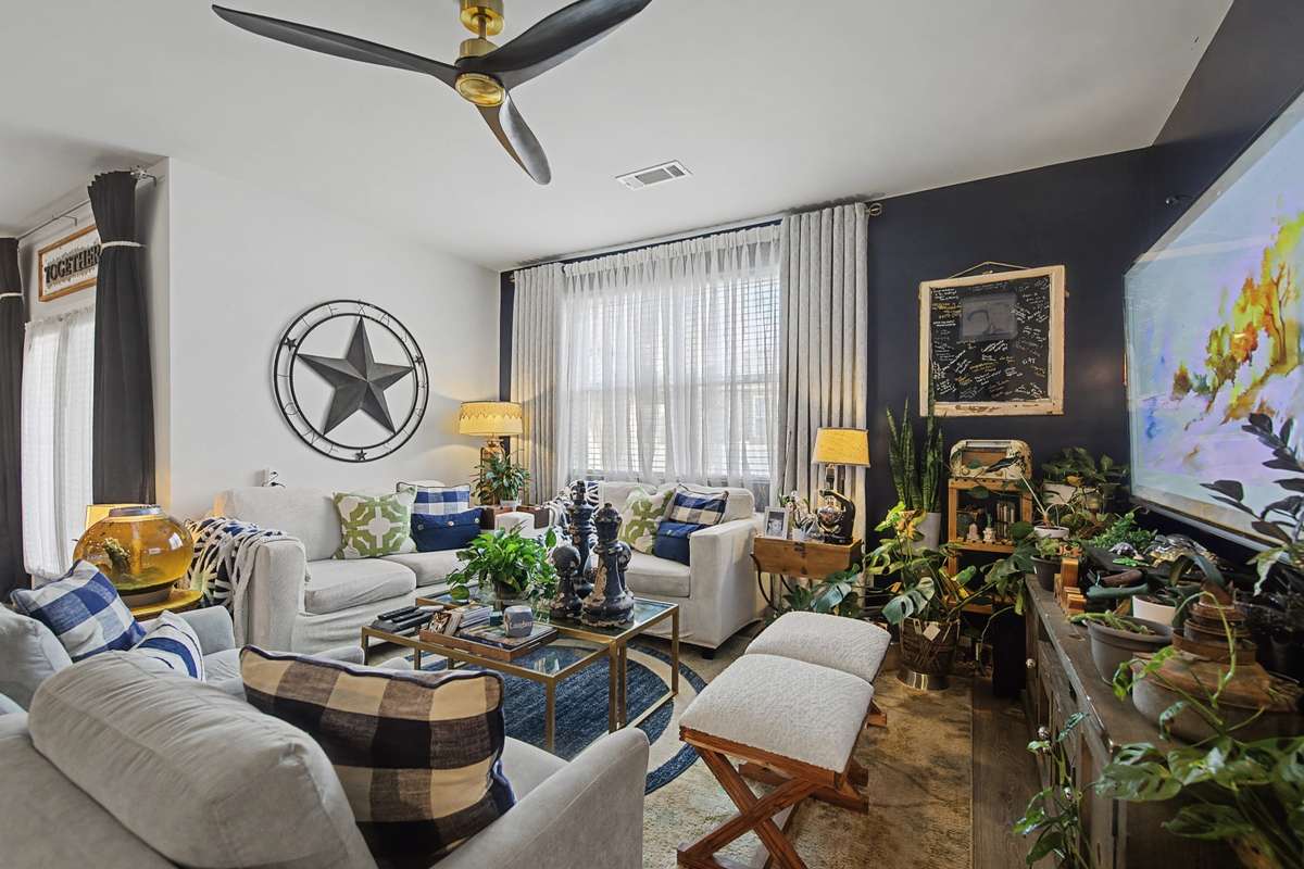 Living Room (Alternative View): Spacious family room designed for entertaining, accented by large windows and modern finishes.