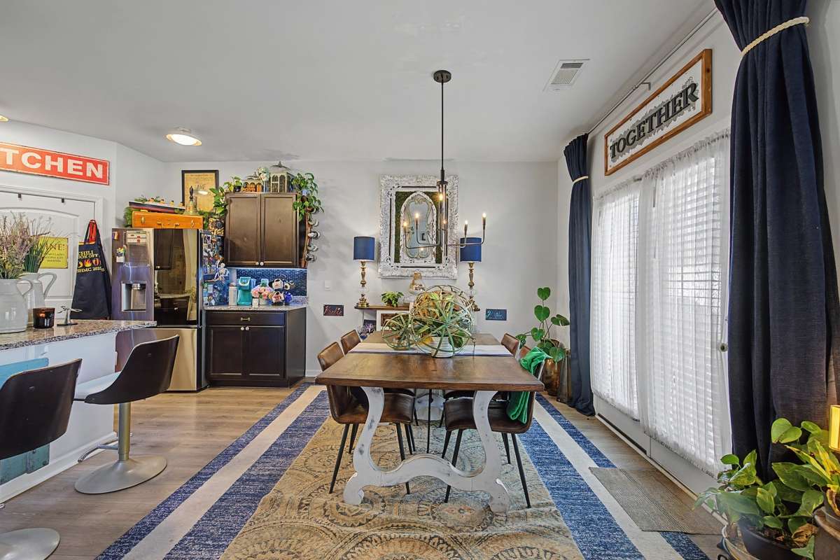 Dining Area: Dedicated dining space adjacent to the kitchen with direct access to the backyard through glass French doors