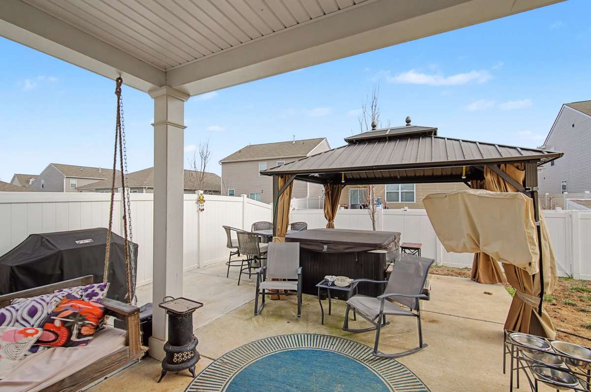 Covered Patio: Relaxing covered rear patio, ideal for outdoor dining and shaded afternoon retreats.