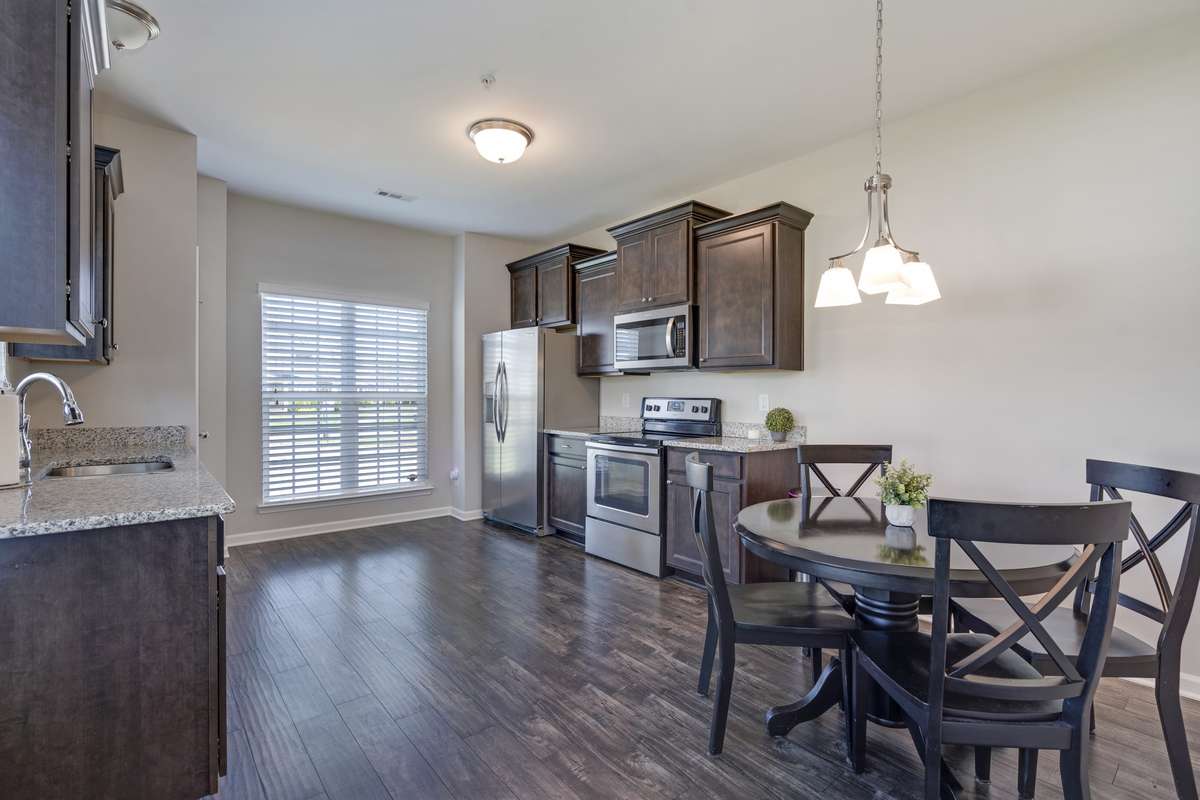 Open kitchen/casual dining area offers ample cabinet space, stainless steel appliances, and nice amount of natural light