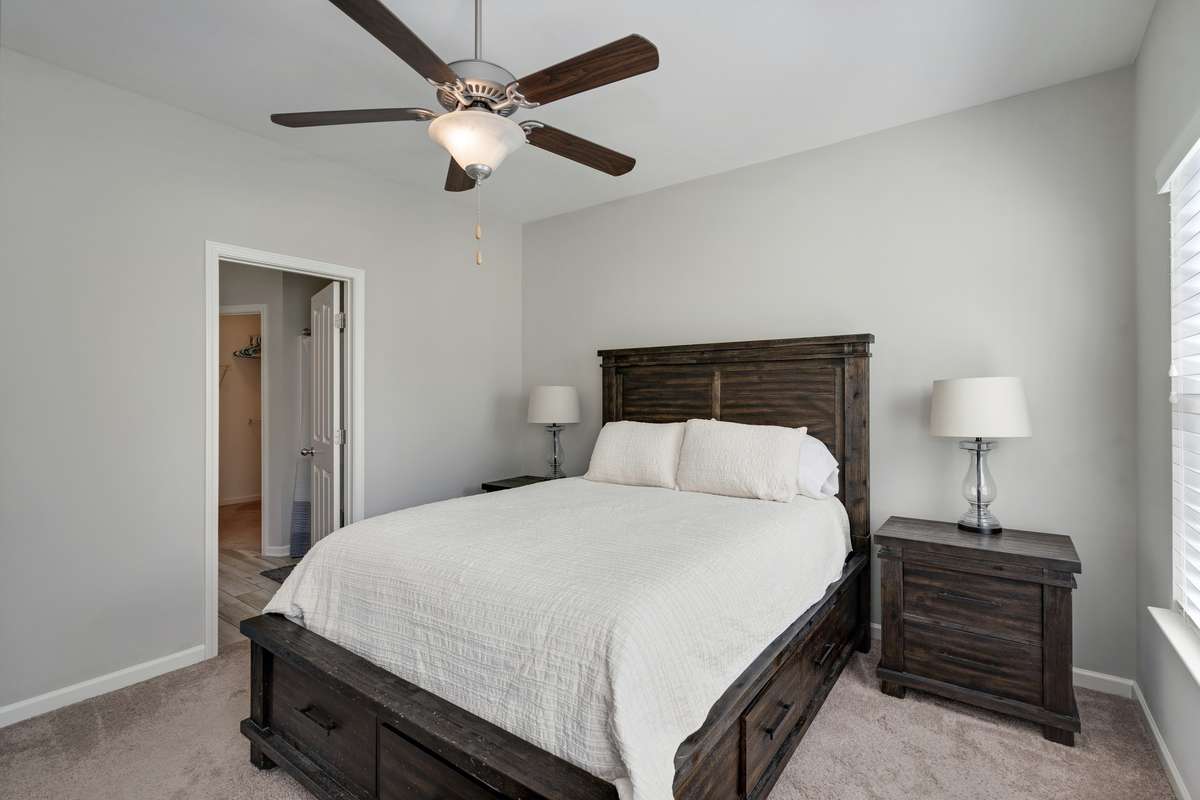 Another angle of the owner's suite showing the door leading to owner's bath