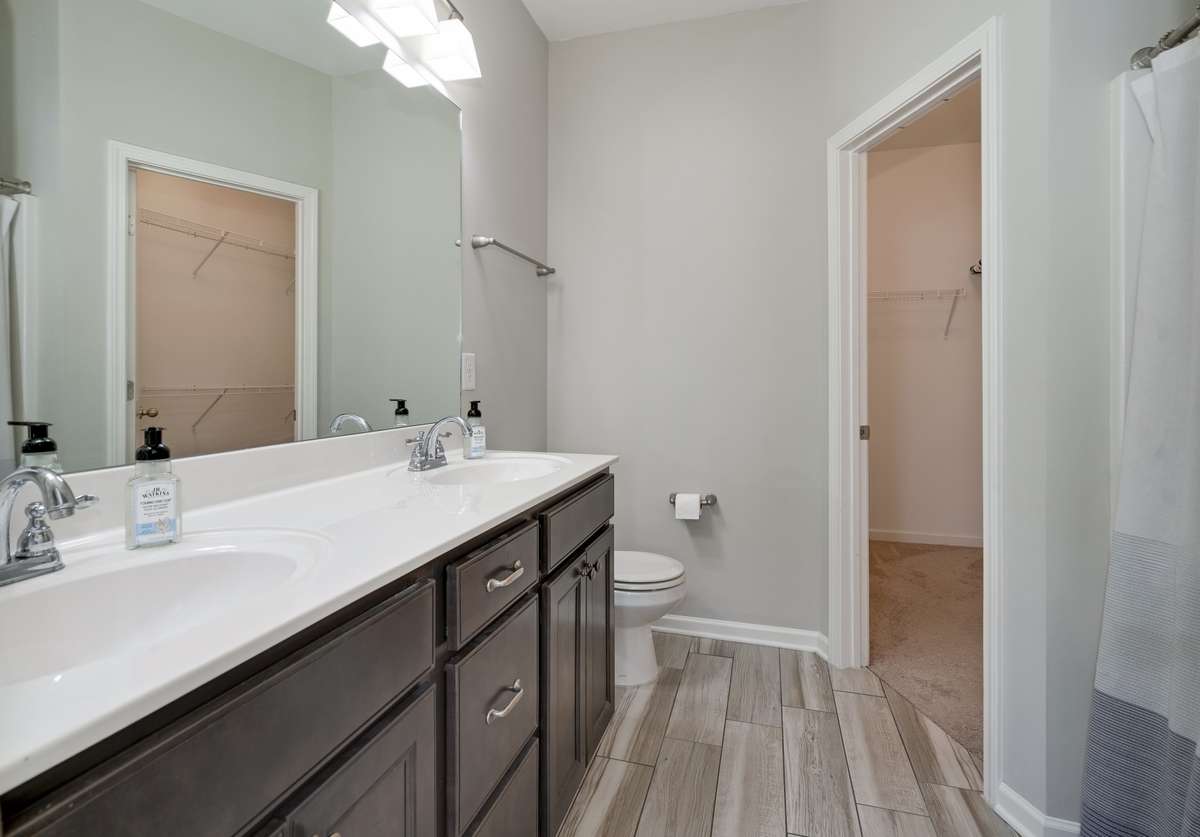 Owner's bath has double bowl vanity