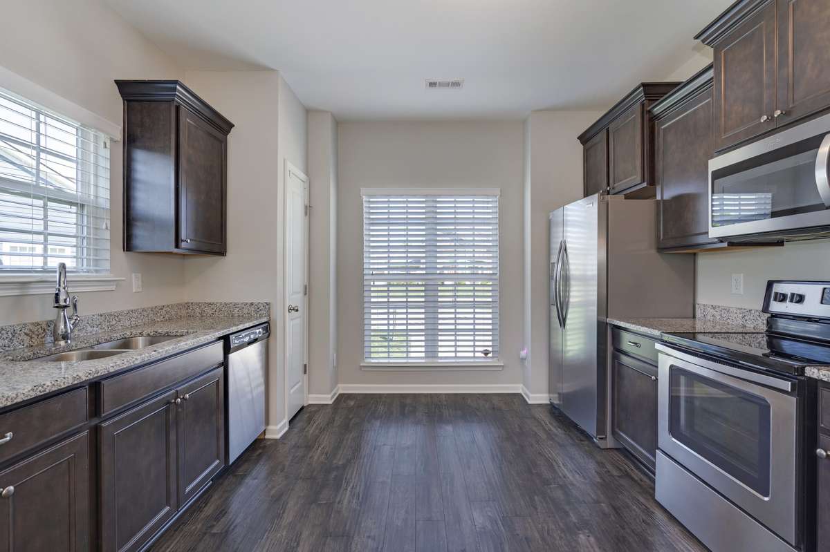Another view of the kitchen showing off the cabinet space and natural light