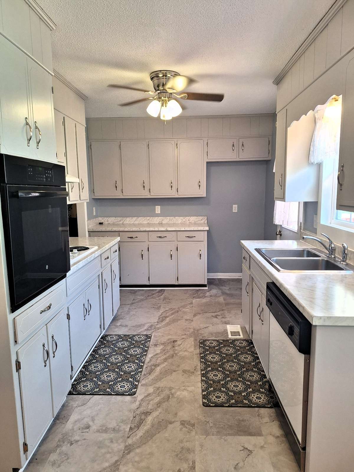 the kitchen has been freshened up with vinyl floors and solid hardwood cabinets for you too!!
