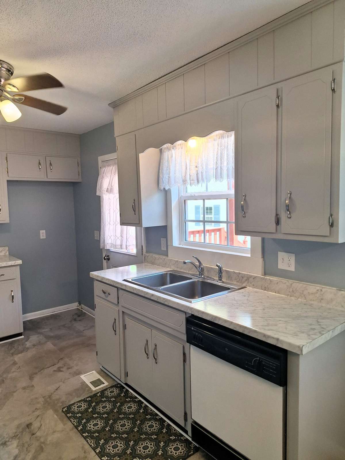 Enjoy overlooking the beautiful backyard while cleaning up the kitchen through the perfectly placed window!!