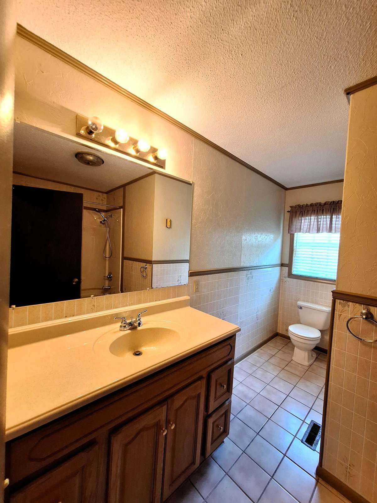 Guest bathroom with a tub/shower combo and tile floors!!