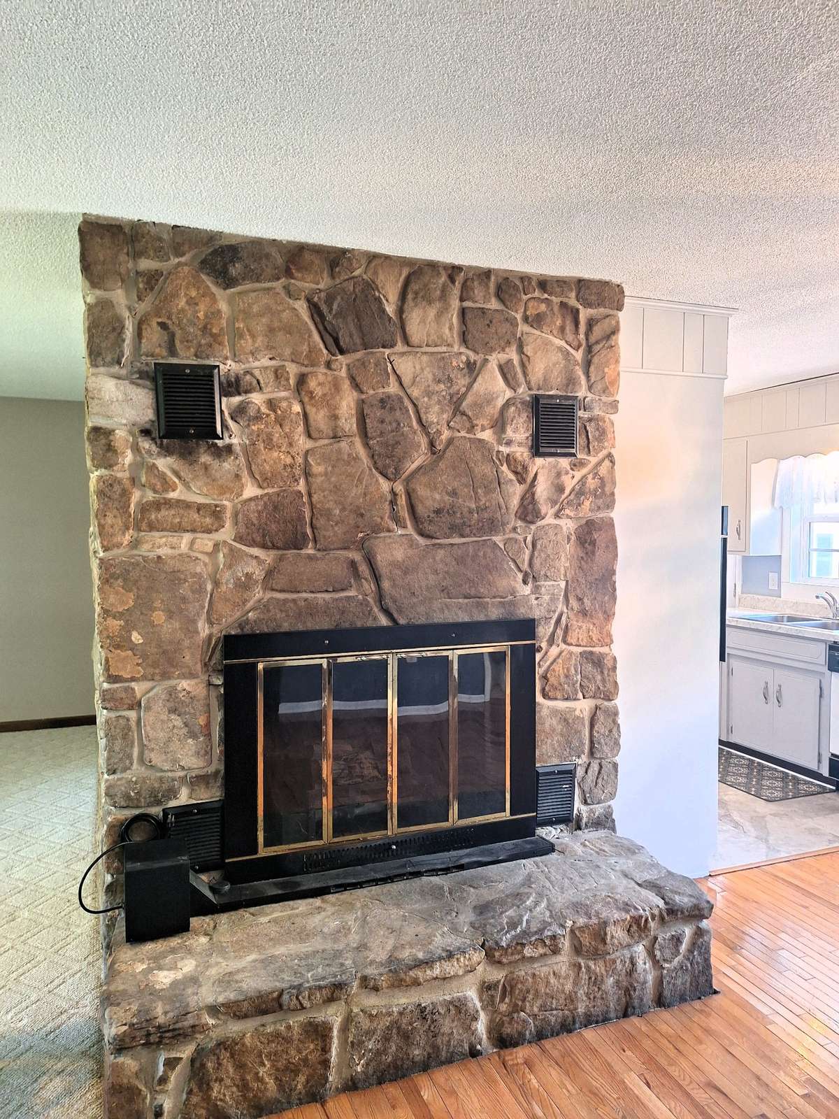 Take a look at the beautiful mountain stone fireplace that now holds electric logs!!