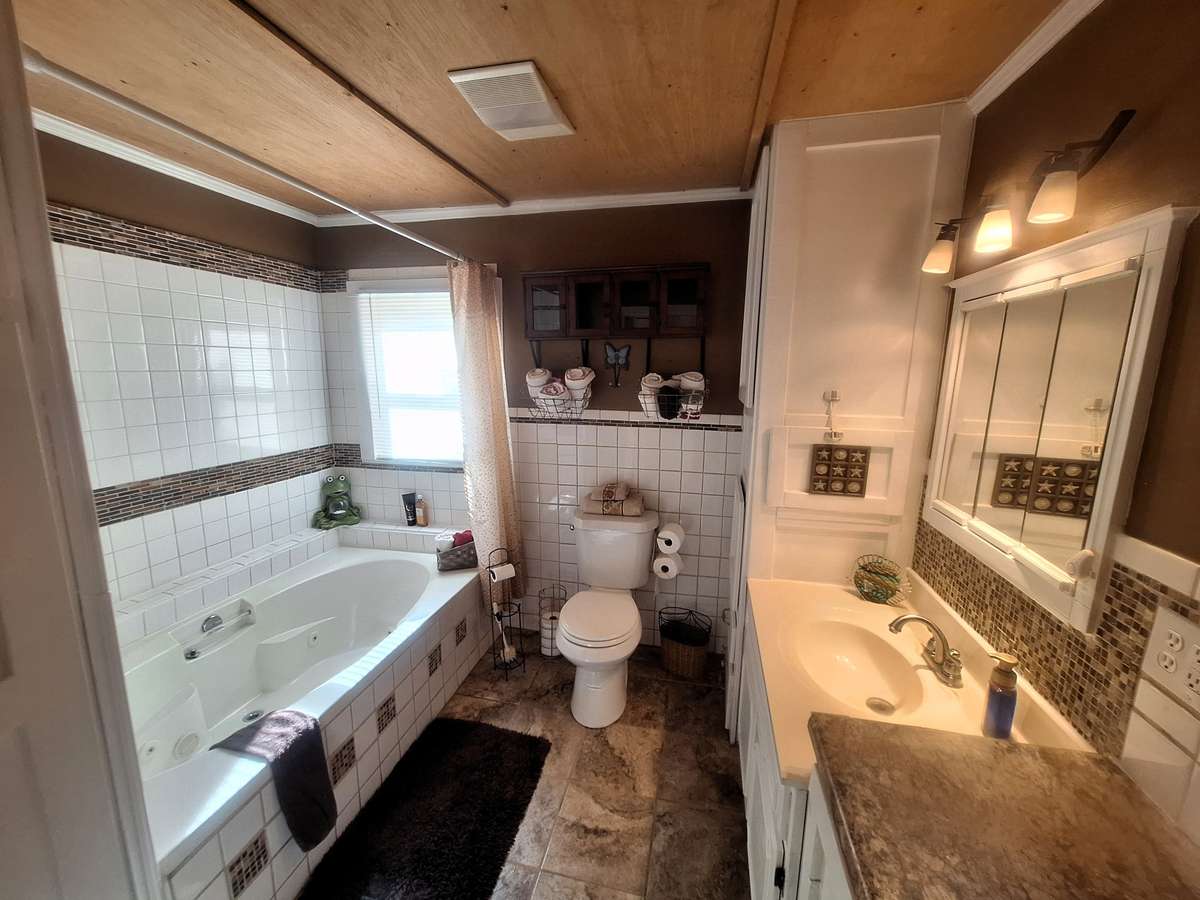 What a Bathroom!! Large Jacuzzi Tub, Spacious Vanity with makeup spot too and tile floors!!