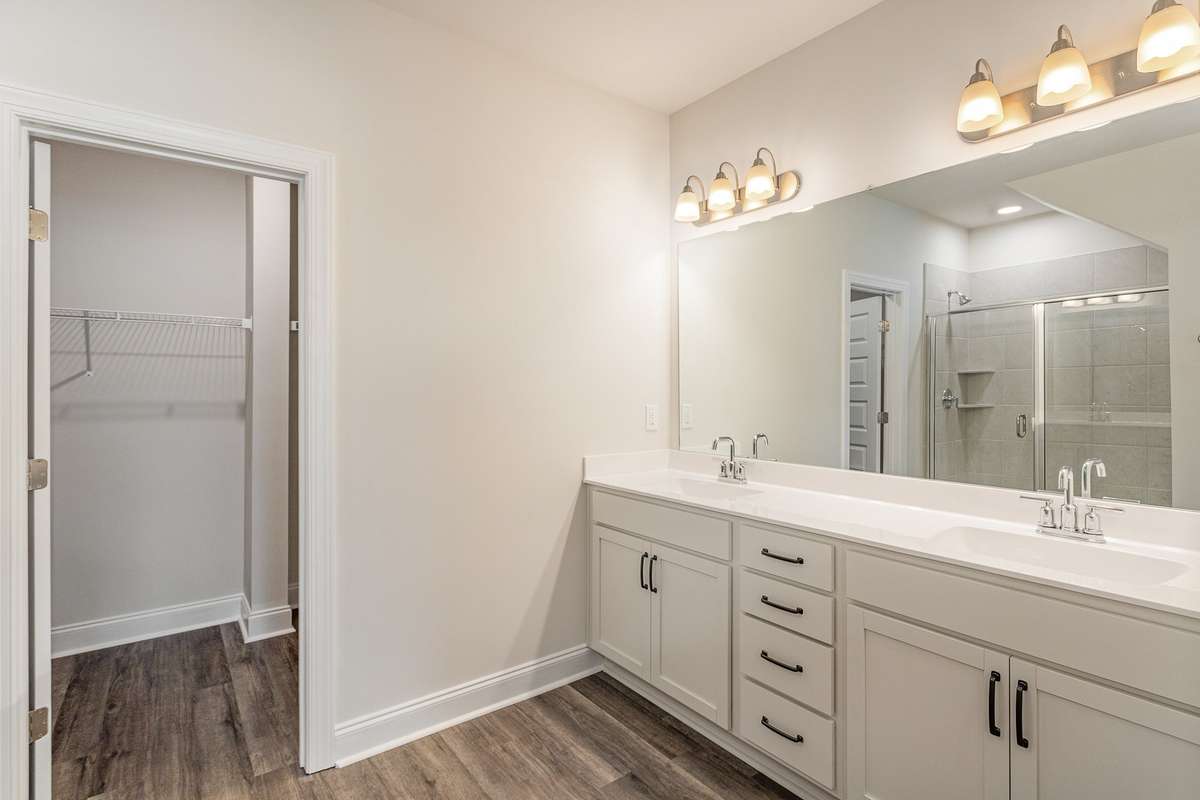 Primary Bath includes double vanities, quartz countertops, and tile shower *Photos not of exact home*