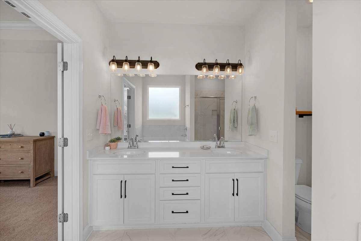 The white cabinets with black handles really look great.