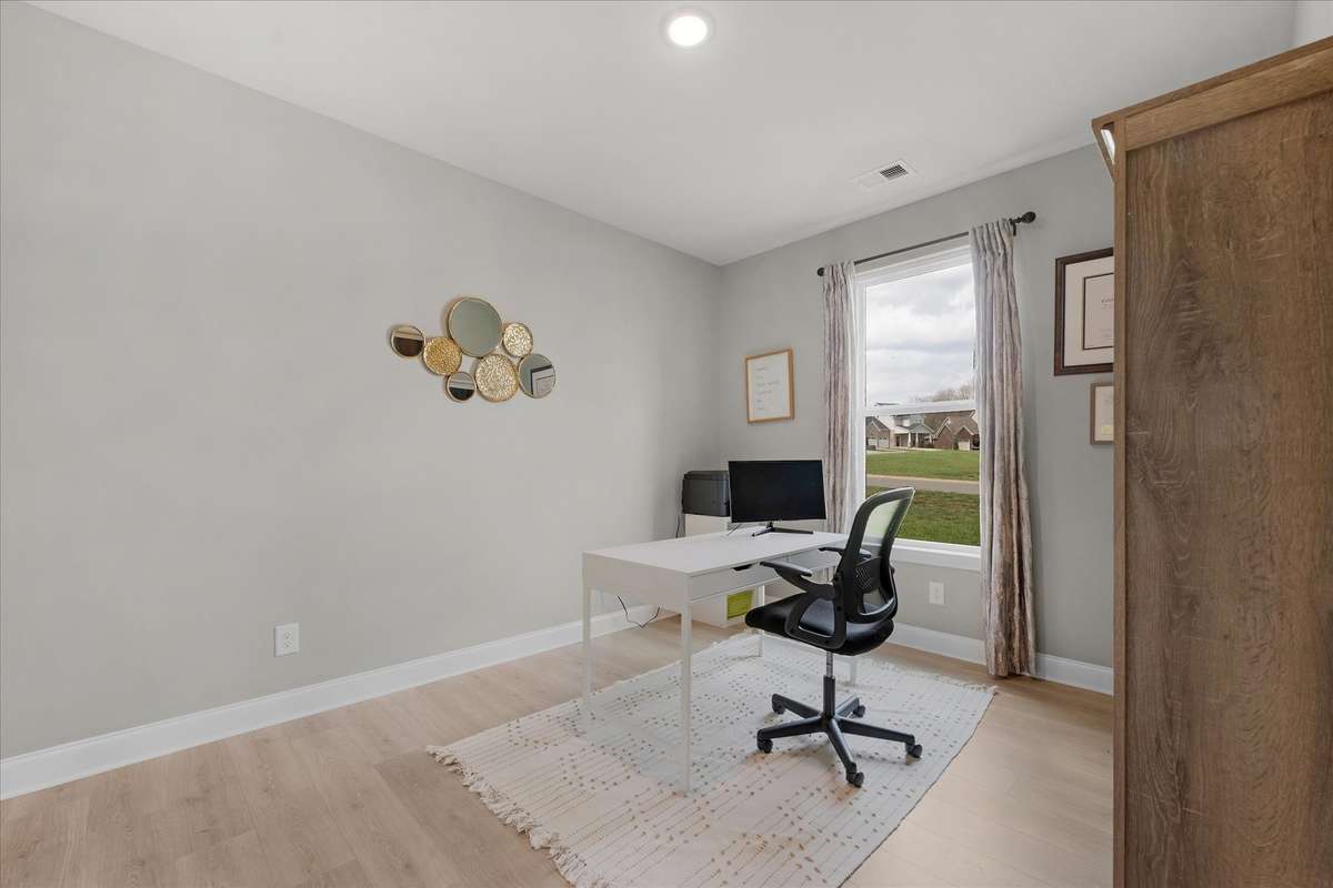 Bedroom 4 is a tad smaller and also has a small closet. It's versatile and would work great as an office, exercise room or a nursery. It is just off the hall to the primary suite.