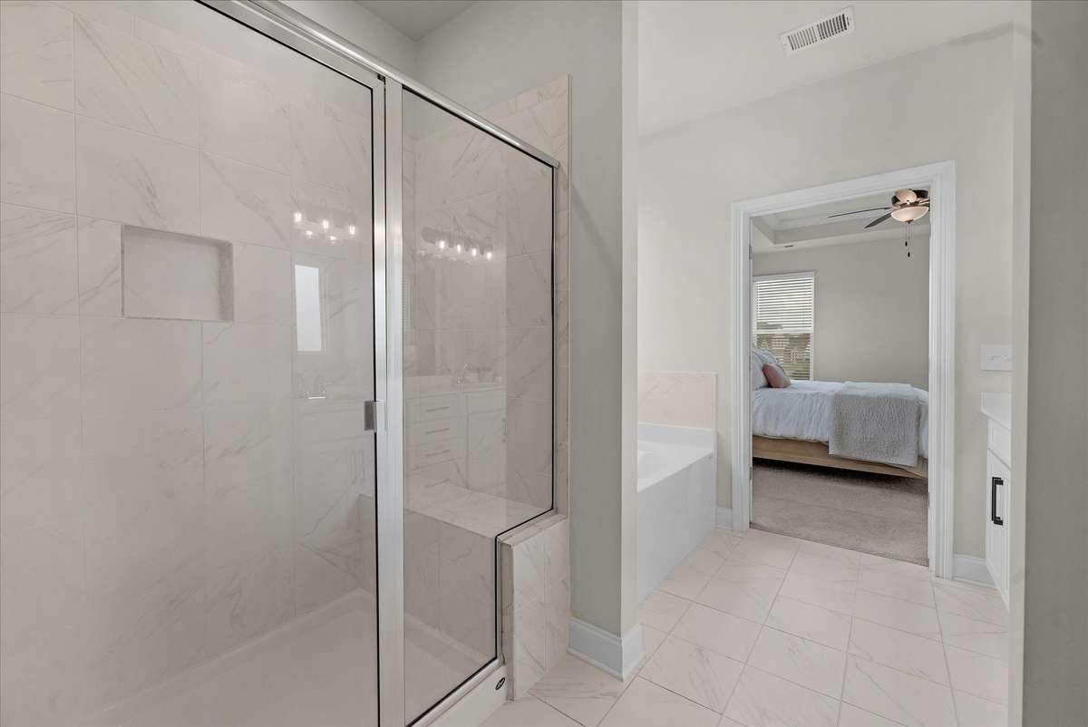 Large itles shower with a seat make this bathroom complete.