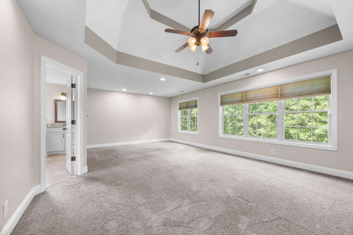 huge primary bedroom upstairs that features a spacious full bath, with separate tub and shower, separate double vanity sinks, makeup vanity and a walk-in closet the size of a bedroom